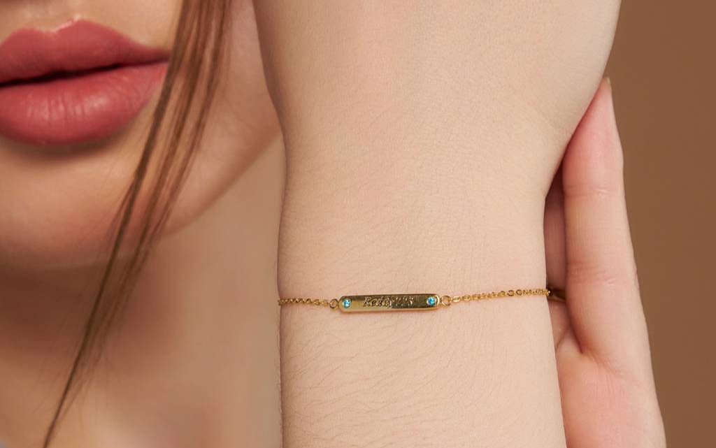 Woman wearing 18K gold vermeil engraved name bracelet on wrist
