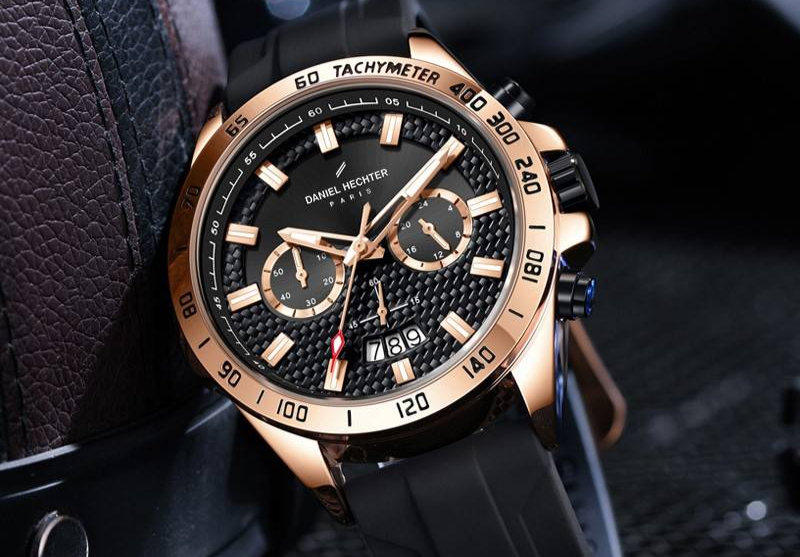 Rose gold chronograph watch with rose gold mesh band on wrist