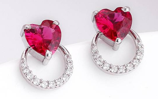 Red gemstone drop earrings displayed on white background