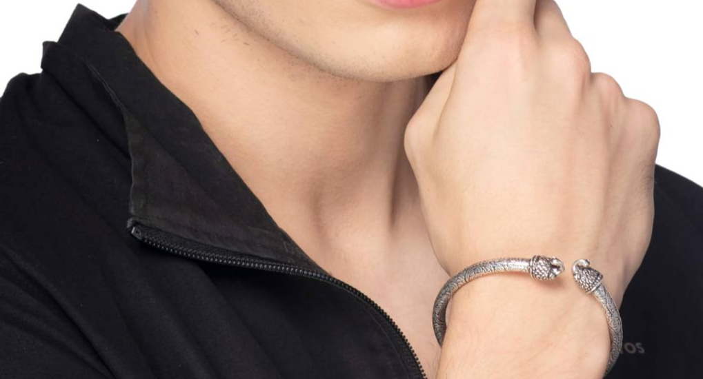 Silver plated stainless steel metal kada bracelet on pink background