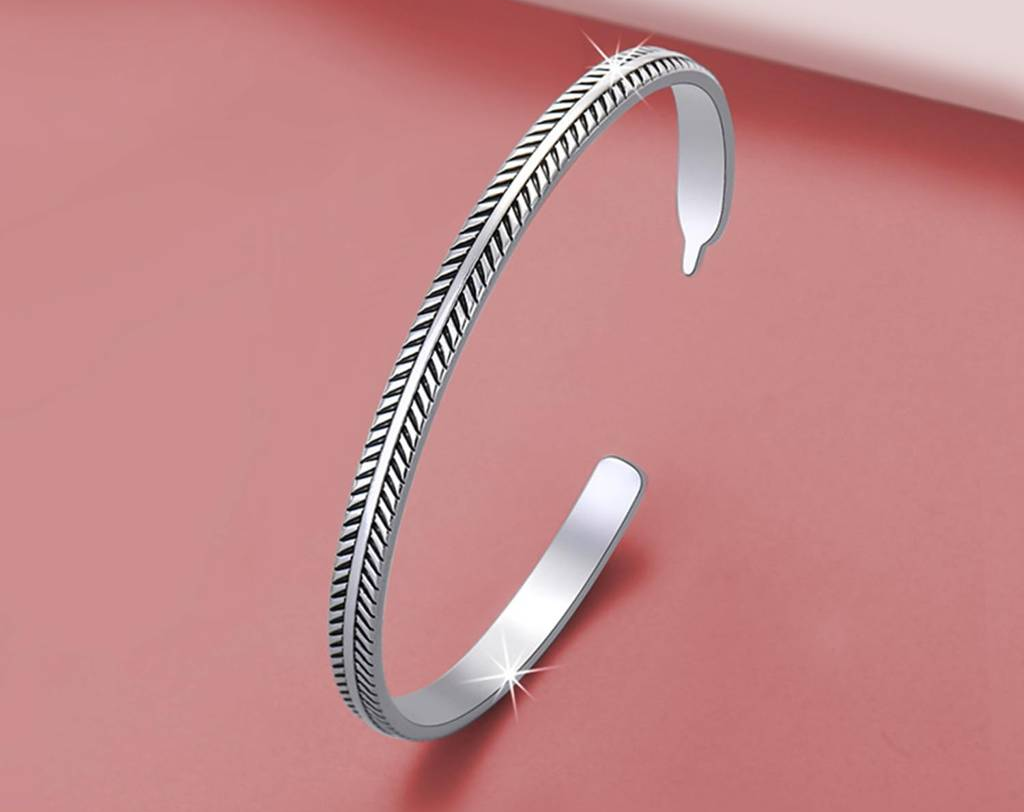 Man wearing silver stainless steel kada bracelet on wrist