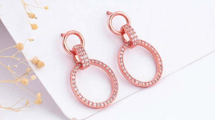 Rose gold shiny drop earrings featuring pink cubic zirconia