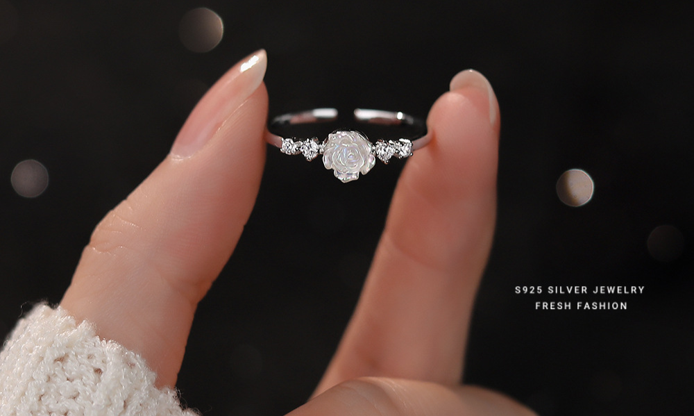 Woman wearing 925 sterling silver opal rose adjustable ring on wrist