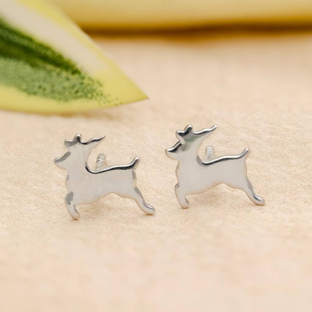Close-up of silver reindeer stud earrings on sandy background from Eternz premium jewelry collection.