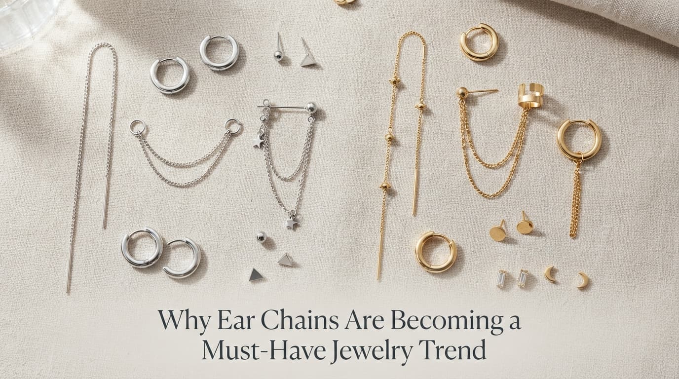 Flat lay of sterling silver and 14k gold ear chains with small huggie hoops and stud earrings for layered ear styling.